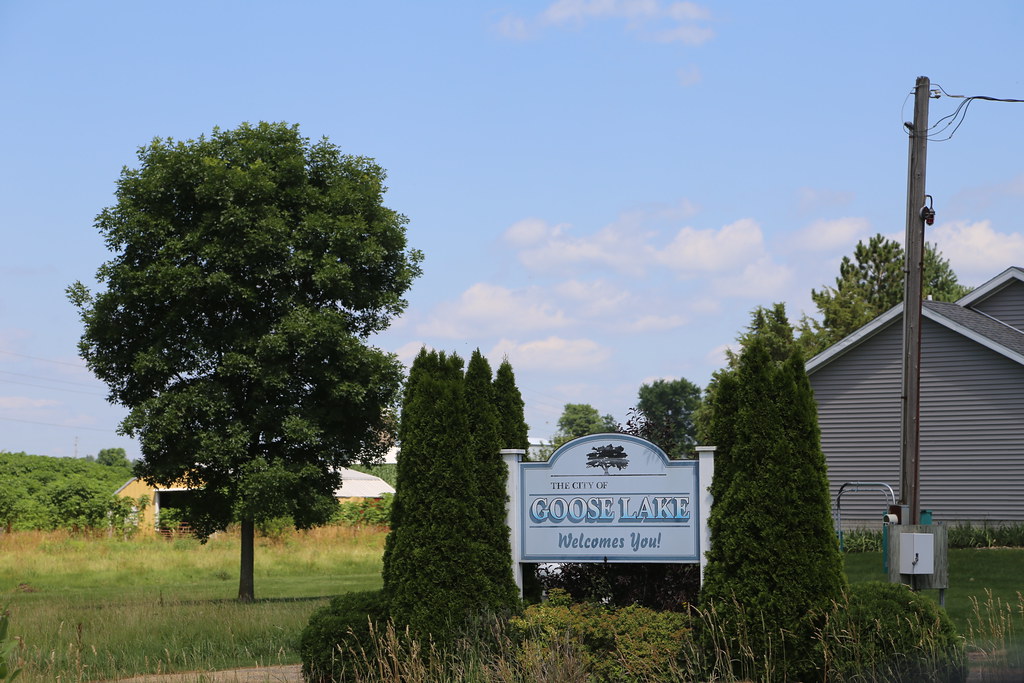 Welcome sign of City of Goose Lake at a location which looks like a park